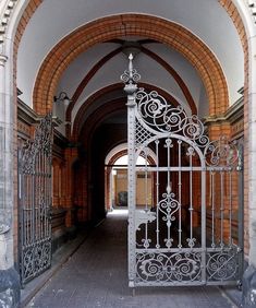 an ornate iron gate is open to the hallway