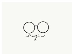 the word imagine written in cursive writing on a white background with black glasses