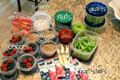 there are many fruits and vegetables in plastic containers on the kitchen counter with labeled labels