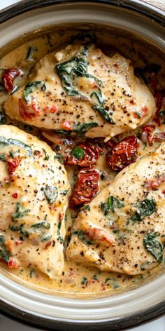 chicken with tomatoes and spinach in a white sauce