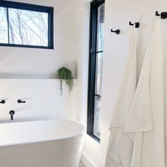 a white bath tub sitting next to a window