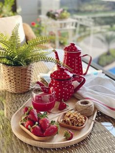 strawberries, nuts and tea on a table outside