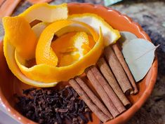 an orange plate with cinnamon, cloves and spices