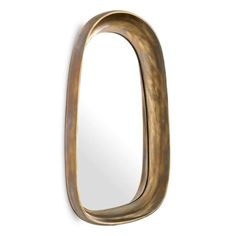 an oval shaped mirror hanging on the wall