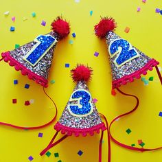 two birthday hats with the number twenty five on them and confetti around it