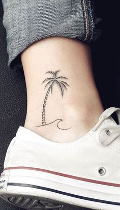 a small palm tree tattoo on the ankle