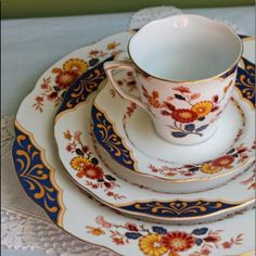 an ornately decorated china dinner set with blue and gold trimmings on it