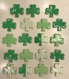 some green and white decorated cookies are on a counter top, one is for st patrick's day