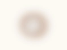 an image of a white circle on a beige background with the light reflecting off it's center