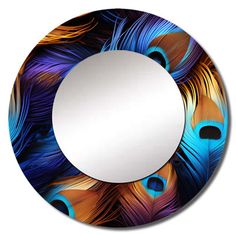 a round mirror with blue and orange feathers on it's side, in front of a white background