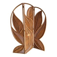 a decorative wooden sculpture with leaves on it's sides and the top section partially open