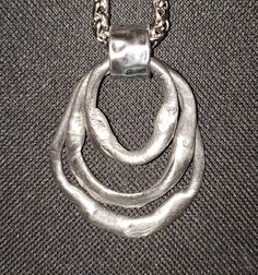 "Beautiful silver triple dangle necklace.  Hand-shaped pewter then heat-forged to its melting point.  May be worn two different versions as pictured.  Triple circle dangle is 2.75\" long and 1.75\" wide.  If worn with one circle up and two down, length of pendant is then 3.25\".  Comes on the wheat design chain as pictured, but you may choose your chain length.  Free shipping!  Comes gift-boxed with a polishing cloth included.  You will always receive the exact item pictured and described. Made Chunky Pendant Necklace, Melting Silver, Chunky Silver Jewellery, Hand Forged Jewelry, Jewel Tattoo, Wheat Design, Pewter Jewelry, Dangle Necklace, Melting Point