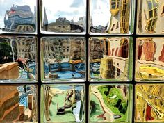 the reflection of several buildings in glass blocks