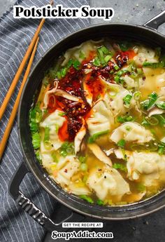 a pot filled with dumplings and vegetables next to chopsticks