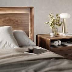 a bed with two nightstands and a lamp next to each other on top of it