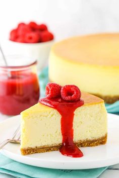 a slice of cheesecake with raspberries on top