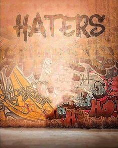 a wall covered in graffiti with the word haters written on it