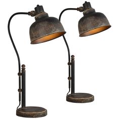 two metal lamps with one light on each side and the other turned on to look like they are standing next to each other