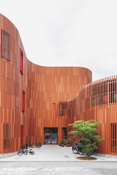 an orange building with several bikes parked in front