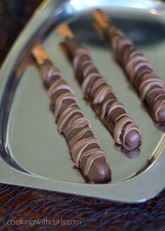 there are four chocolate sticks on the tray