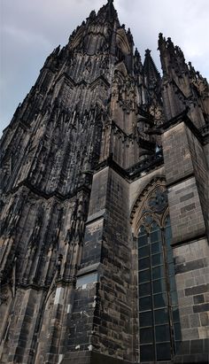 an old gothic building with many windows and spires