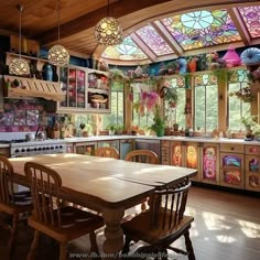 a kitchen with stained glass windows and wooden table surrounded by chairs in front of an oven