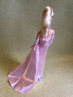 Barbie vintage blonde reproduction collection-Mattel-Enchanted Evening-1996 Barbie vintage blonde reproduction collection-Mattel-Enchanted Evening-1996 Beautiful Barbie wearing her pink strapless satin evening gown with a pink rose detail at the waistline, and white fur, pink satin lined stole, triple strand pearl choker necklace, pearl earrings, clear see through gold glitter peep toe stiletto shoes, and long white evening gloves. She comes with her clear plastic original Barbie stand and pink Pink Feminine Gown For Gala, Feminine Pink Gown For Gala, Pink Satin Finish Evening Dress For Prom, Elegant Pink Gown With Satin Finish, Pink Satin Finish Evening Dress For Gala, Pink Satin Gown For Formal Occasions, Formal Pink Satin Gown, Pink Satin Gown For Gala, Feminine Pink Satin Evening Dress