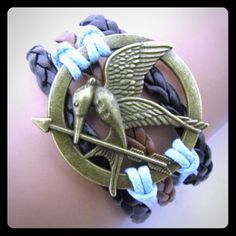 Mocking Jay (Hunger Games) Multilayer Bracelet. Black, Blue, And Brown Strands With A Bronze Tone Charm. 7" Long With 2" Extender Chain And Lobster Clasp. New In Package, No Tag. Hunger Games Bracelet, Arrow Bracelet, Christmas Bracelet, Christmas Knitting, Love Bracelets, Wedding Bracelet, Braided Leather, Hunger Games, Bracelet Gift