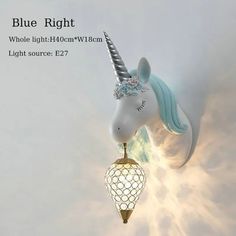 a blue and white unicorn clock hanging from the ceiling