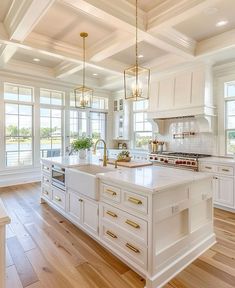 a large kitchen with white cabinets and wood flooring is pictured in this image from the inside