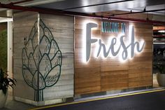 there is a sign that says welcome to fresh on the side of a building at night