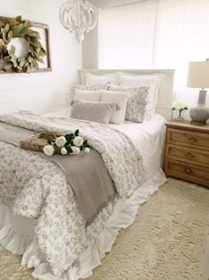 a bed with white sheets and flowers on it