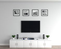 a flat screen tv mounted to the side of a white entertainment center in a living room