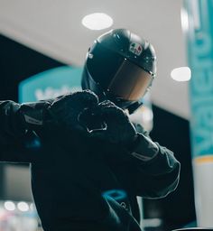 a person wearing a black jacket and helmet