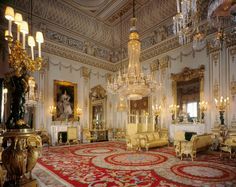 an ornately decorated room with chandeliers and chairs