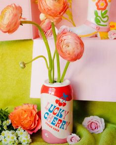 pink flowers are in a lucky cherry can