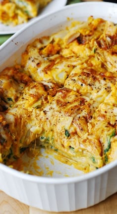 a casserole dish with cheese and spinach in it