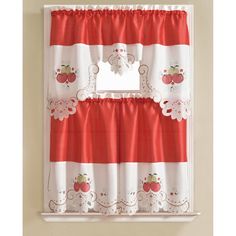 a red and white window curtain with apples on it