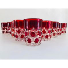 a group of red glasses sitting next to each other