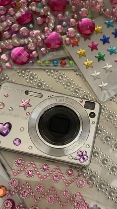 a camera sitting on top of a table covered in beads