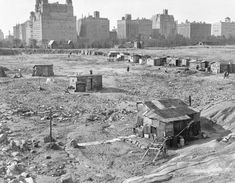 an old black and white photo of some buildings in the distance with no people around them