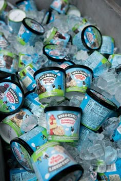 many ice creams are sitting in a container on top of some ice cubes