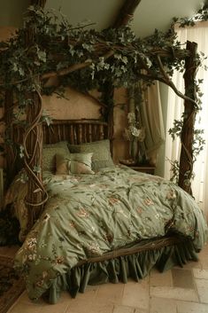 a bed with green comforter and pillows in a bedroom next to a window covered by vines