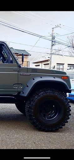 a green jeep is parked on the street