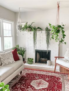 a living room filled with furniture and a fire place in front of a white brick fireplace