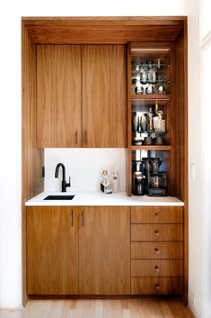 a kitchen with wooden cabinets and white counter tops