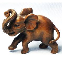 an elephant figurine is shown on a white background