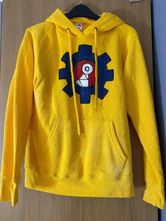 a yellow hoodie with a cartoon character on it