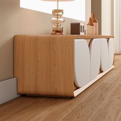 a room with wooden flooring and a white cabinet next to a lamp on the wall