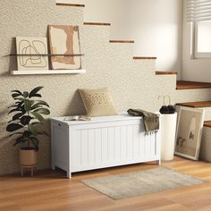 a white bench sitting on top of a hard wood floor next to a potted plant